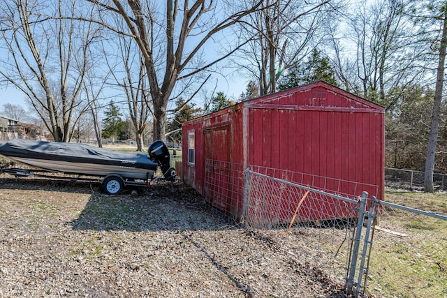 view of outdoor structure featuring an outbuilding and fence