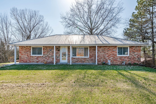 ranch-style home with a front lawn, brick siding, and metal roof