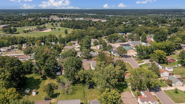 drone / aerial view featuring a residential view and a view of trees