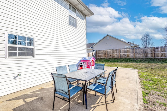 view of patio with outdoor dining area and a fenced backyard