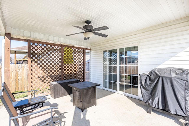 view of patio featuring a grill, fence, and ceiling fan