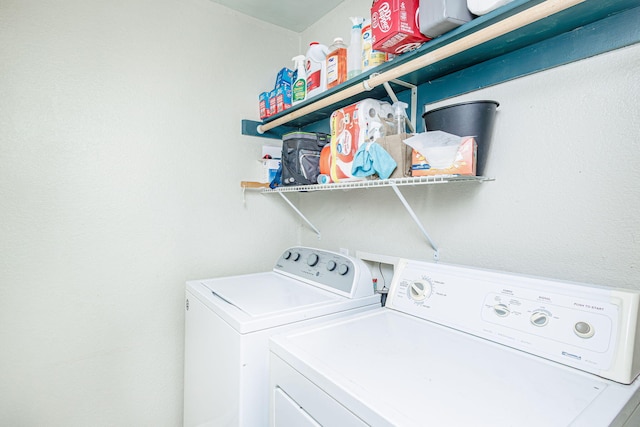 clothes washing area with laundry area and washer and clothes dryer