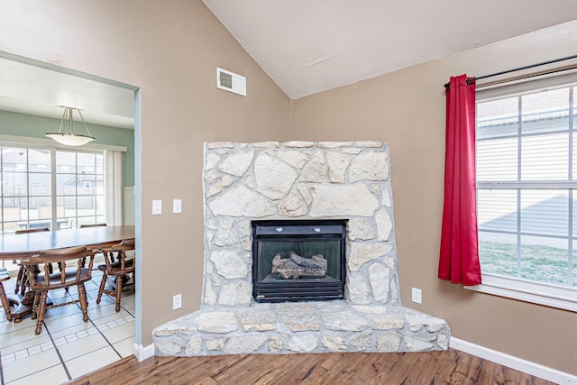 room details featuring a fireplace, wood finished floors, visible vents, and baseboards