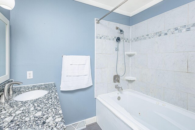 bathroom featuring bathtub / shower combination, vanity, baseboards, and visible vents