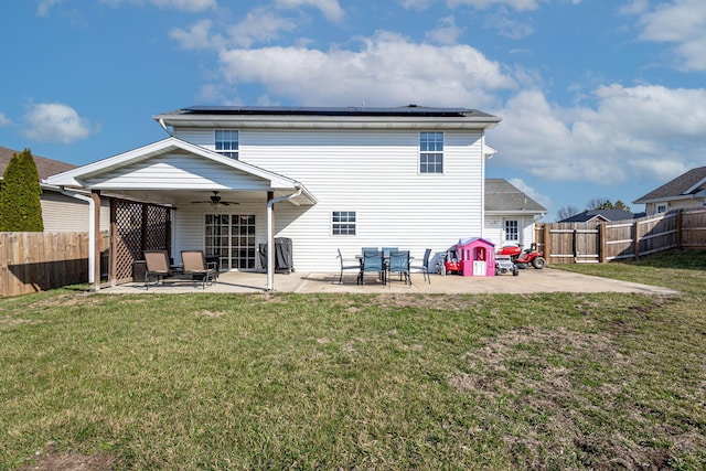 rear view of property with a lawn, a fenced backyard, a ceiling fan, and a patio area