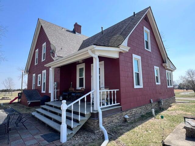 exterior space with a chimney and a shingled roof