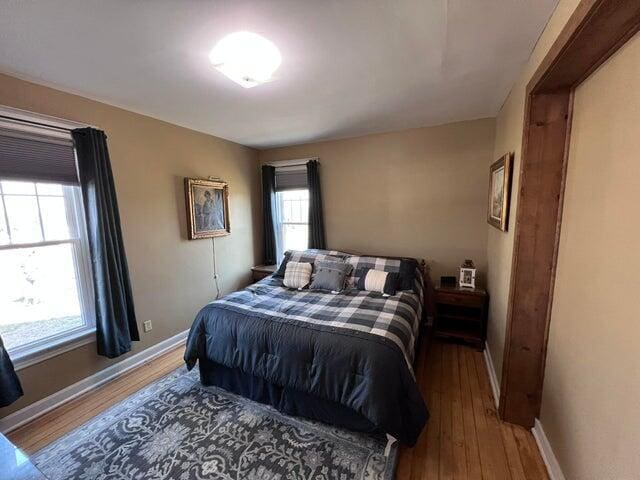 bedroom featuring baseboards and wood finished floors