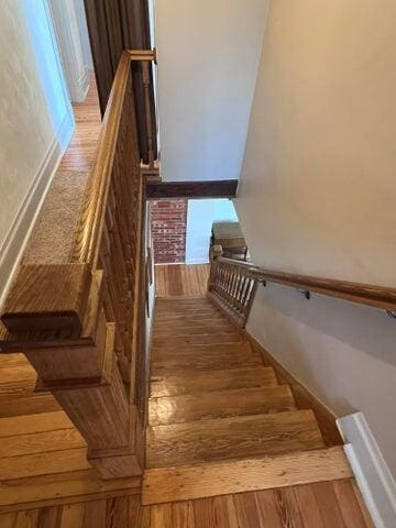 staircase with wood finished floors