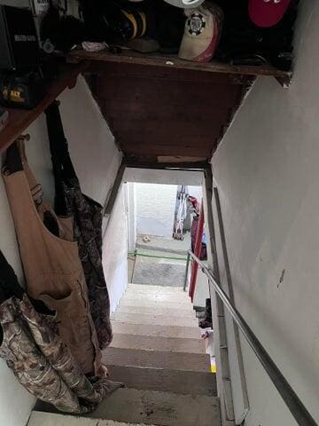 stairway with wood finished floors