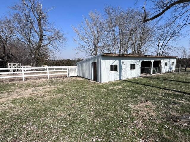 view of pole building with fence