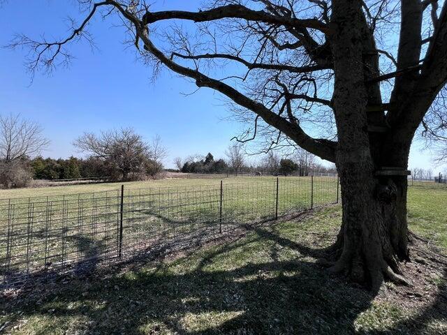 view of yard featuring a rural view and fence