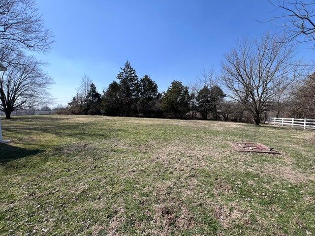 view of yard featuring a rural view and fence