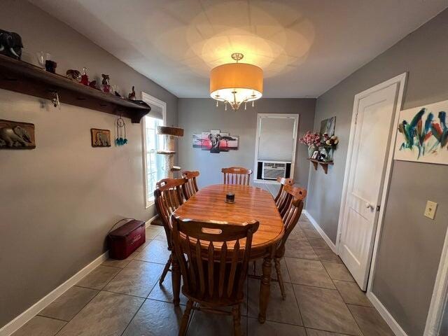 dining space featuring tile patterned floors, cooling unit, and baseboards