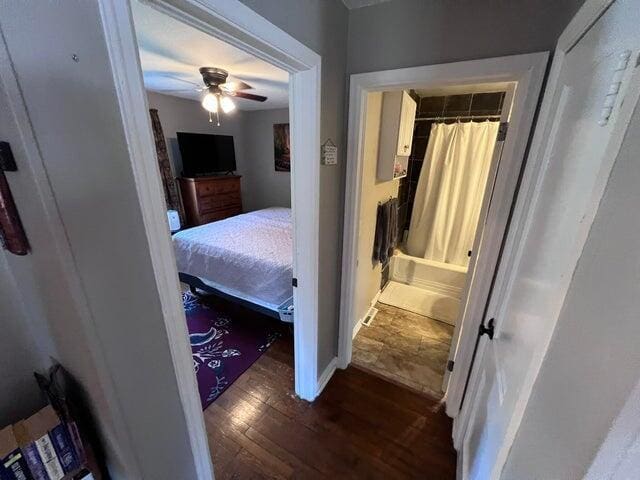 bedroom with baseboards, dark wood-style flooring, and ceiling fan