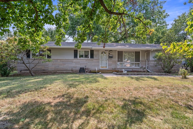 ranch-style home with stone siding and a front yard