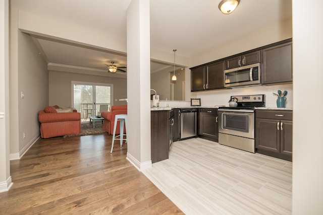 kitchen featuring dark brown cabinetry, light wood finished floors, appliances with stainless steel finishes, and a ceiling fan