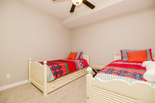 carpeted bedroom with baseboards and a ceiling fan