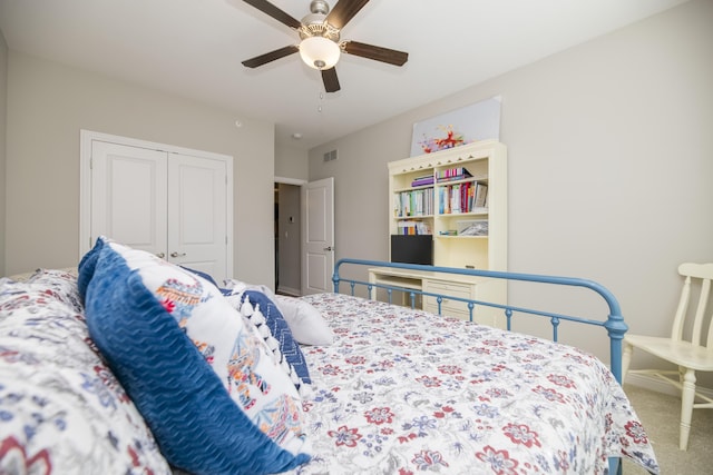 bedroom with visible vents, carpet floors, a closet, and a ceiling fan