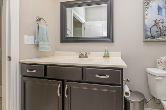 bathroom featuring toilet and vanity