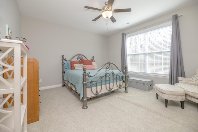 carpeted bedroom featuring visible vents, baseboards, and ceiling fan