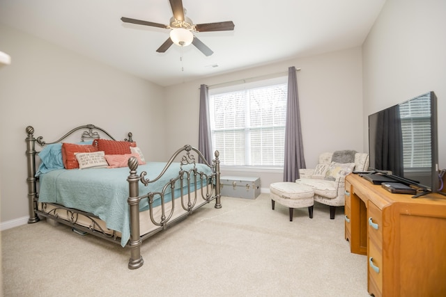 bedroom featuring a ceiling fan, baseboards, and light carpet