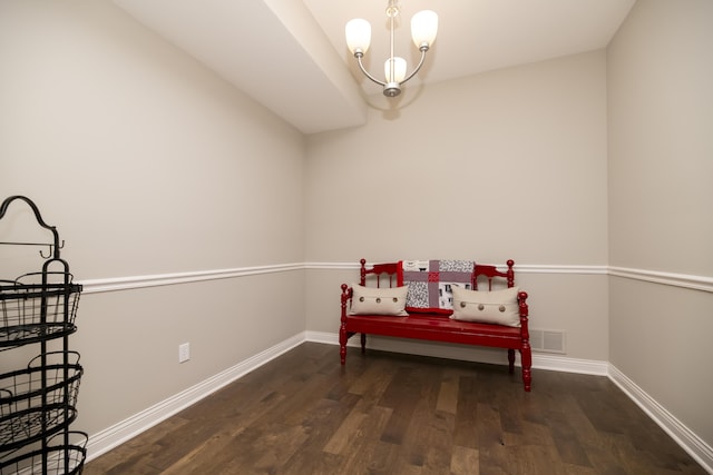 living area featuring a notable chandelier, wood finished floors, and baseboards