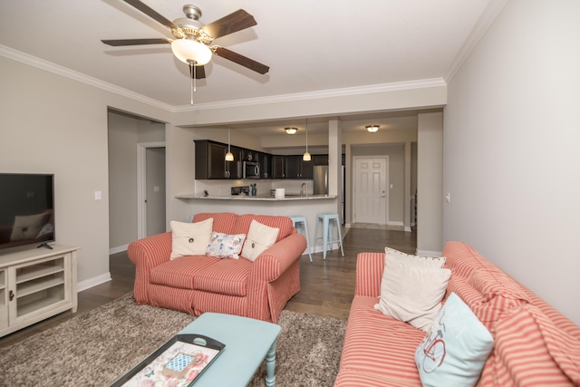 living area with dark wood-style floors, baseboards, ornamental molding, and a ceiling fan