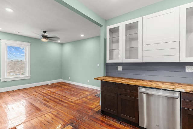 bar with dishwasher, baseboards, a ceiling fan, and dark wood-style flooring