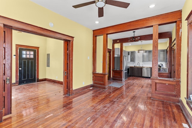 entrance foyer featuring baseboards, beam ceiling, electric panel, dark wood-style flooring, and ceiling fan