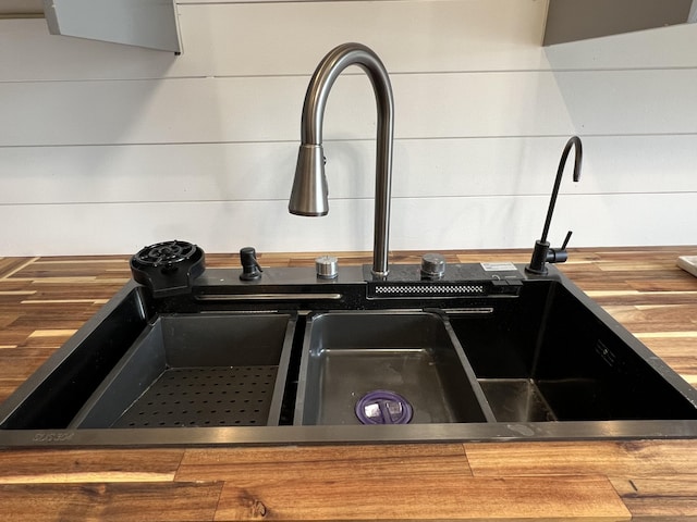 interior details featuring butcher block counters and a sink