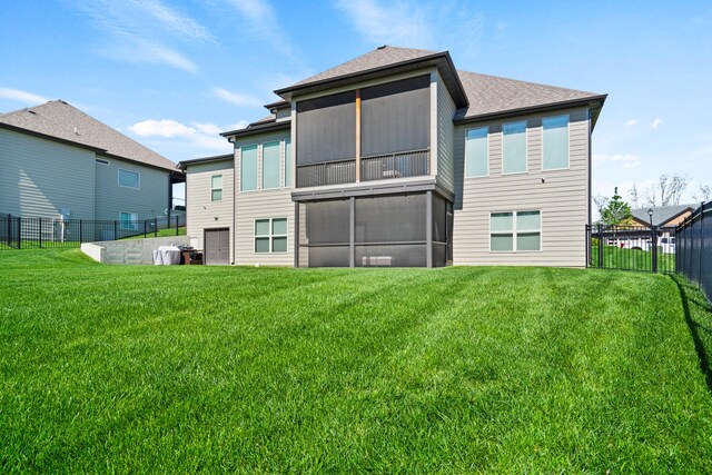 back of property featuring a fenced backyard, a shingled roof, and a lawn