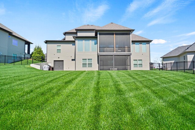 back of property with a lawn and a fenced backyard
