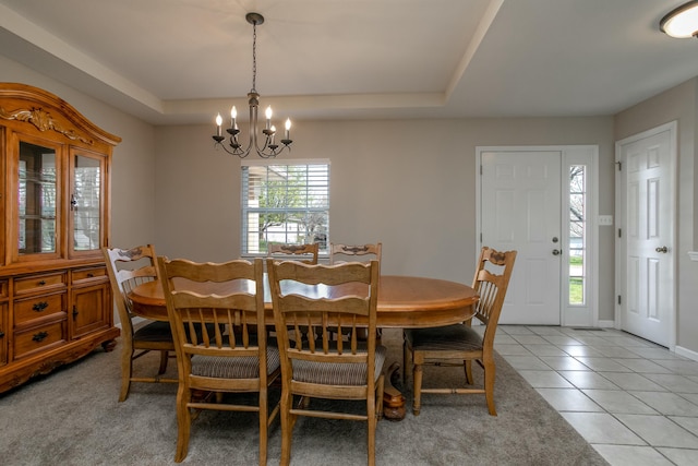 4612 Manhasset Dr, Columbia, MO 65203 - dining area with a tray ceiling, a chandelier, and light tile patterned floors