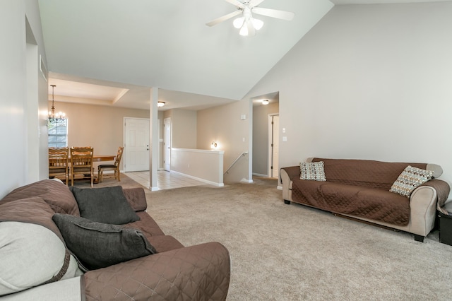 4612 Manhasset Dr, Columbia, MO 65203 - living room with high vaulted ceiling, baseboards, light carpet, and ceiling fan with notable chandelier