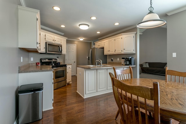 4612 Manhasset Dr, Columbia, MO 65203 - kitchen with white cabinets, stainless steel appliances, recessed lighting, and crown molding