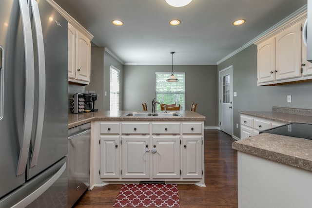 4612 Manhasset Dr, Columbia, MO 65203 - kitchen with crown molding, a sink, stainless steel appliances, a peninsula, and recessed lighting