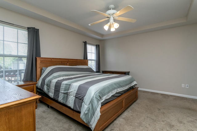 4612 Manhasset Dr, Columbia, MO 65203 - bedroom featuring ceiling fan, light carpet, baseboards, and a raised ceiling