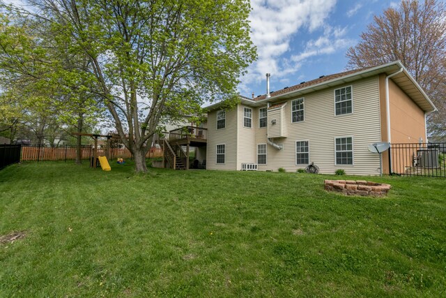 4612 Manhasset Dr, Columbia, MO 65203 - rear view of house with a fire pit, a yard, and a fenced backyard
