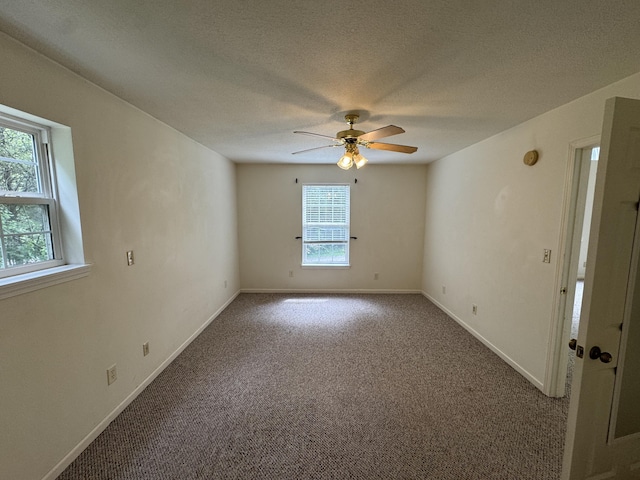 6112 E Forsee Rd, Ashland, MO 65010 - carpeted empty room featuring healthy amount of natural light, ceiling fan, baseboards, and a textured ceiling
