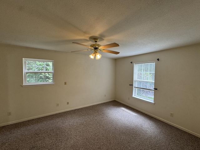 6112 E Forsee Rd, Ashland, MO 65010 - spare room featuring a ceiling fan, dark carpet, a textured ceiling, and baseboards