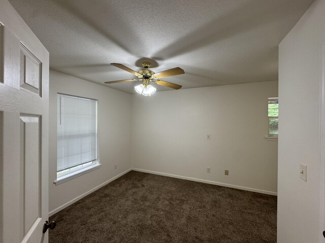 6112 E Forsee Rd, Ashland, MO 65010 - unfurnished room featuring dark carpet, ceiling fan, baseboards, and a textured ceiling