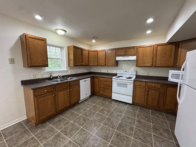 6112 E Forsee Rd, Ashland, MO 65010 - kitchen with white appliances, under cabinet range hood, dark countertops, brown cabinets, and a sink