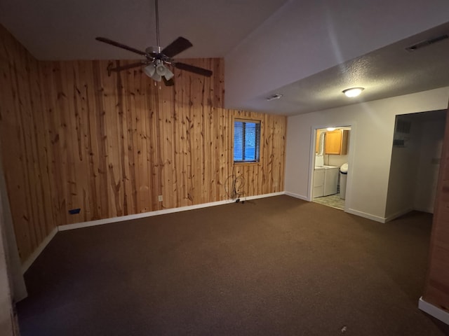 6112 E Forsee Rd, Ashland, MO 65010 - carpeted empty room with wood walls, baseboards, ceiling fan, lofted ceiling, and washer and clothes dryer