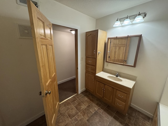 6112 E Forsee Rd, Ashland, MO 65010 - bathroom featuring baseboards, vanity, and a textured ceiling