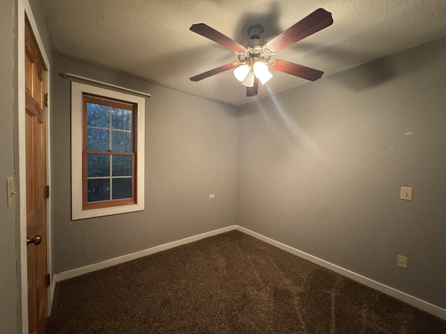 6112 E Forsee Rd, Ashland, MO 65010 - unfurnished room with dark colored carpet, ceiling fan, baseboards, and a textured ceiling