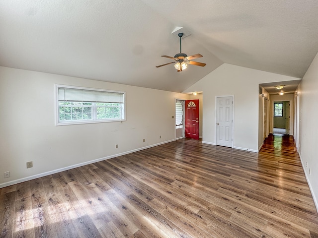 6132 E Forsee Rd, Ashland, MO 65010 - unfurnished living room featuring a wealth of natural light, wood finished floors, a ceiling fan, and lofted ceiling