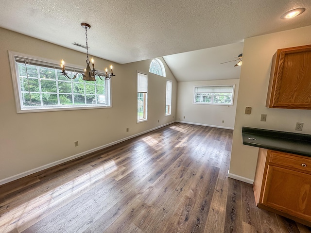 6132 E Forsee Rd, Ashland, MO 65010 - unfurnished dining area with a textured ceiling, visible vents, dark wood-style flooring, and baseboards