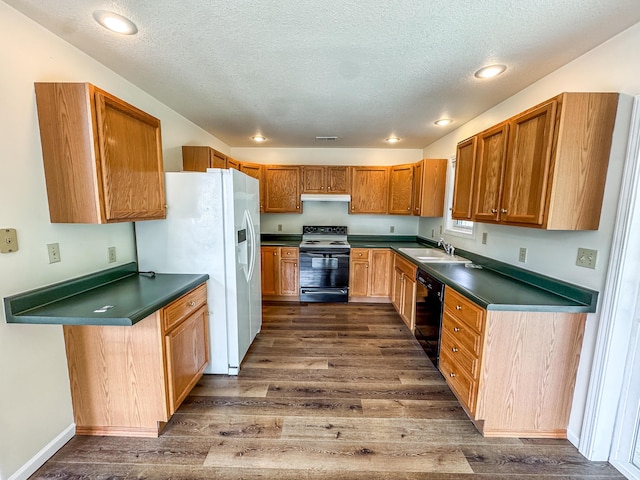 6132 E Forsee Rd, Ashland, MO 65010 - kitchen featuring black appliances, dark countertops, dark wood finished floors, and a sink