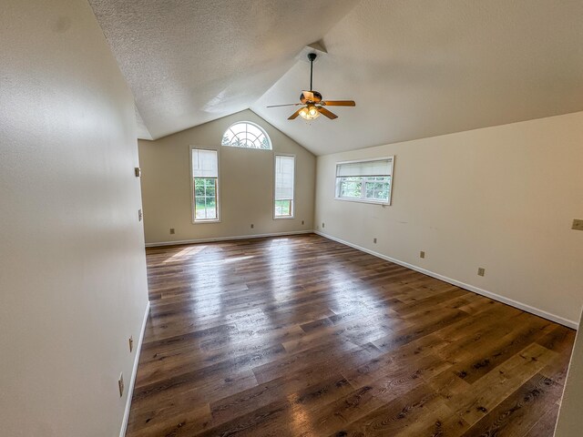 6132 E Forsee Rd, Ashland, MO 65010 - empty room with dark wood-style flooring, a healthy amount of sunlight, ceiling fan, and vaulted ceiling