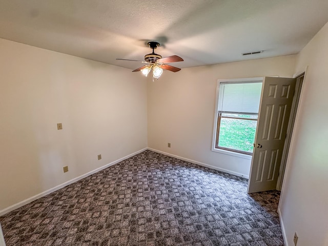 6132 E Forsee Rd, Ashland, MO 65010 - spare room featuring baseboards, a ceiling fan, visible vents, and dark carpet